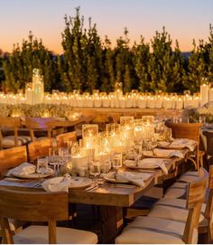 a long table with candles and plates on it