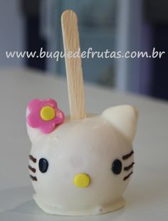 a hello kitty cake popsicle with a wooden stick sticking out of it's head