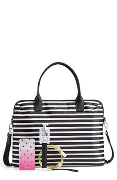 a black and white striped bag with pink polka dots on the front, along with a tag