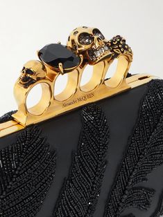 ALEXANDER MCQUEEN Four Ring embellished leather clutch | NET-A-PORTER Designer Engraved Jewelry For Evening, Designer Engraved Evening Jewelry, Luxury Jewelry With Custom Hardware, Porter Bag, Alexander Mcqueen Clutch, Cinch Bag, Summer Style Guide, Flower Motifs, Orlebar Brown