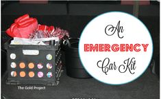 an emergency kit sits on the floor next to a black container with plastic bags in it