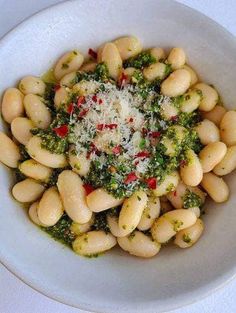 a white bowl filled with pasta and broccoli