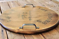 an old wooden board with writing on it sitting on the floor next to a bottle opener