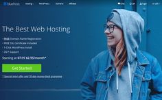 a woman wearing glasses and a hoodie is looking at the web hosting page on her computer