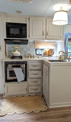 a kitchen with white cabinets and an oven