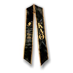 a black and gold tie with the words kao printed on it's side