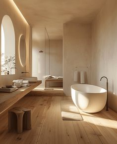 a bath room with a large tub and a sink inside of it on top of a hard wood floor