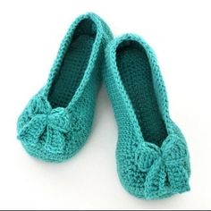 two crocheted shoes with bows on them