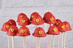 a group of red fireman hats on top of toothpicks