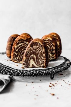 three pieces of cake sitting on top of a white plate next to a wire rack