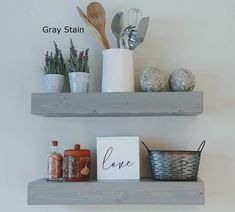 two shelves with pots, spoons and utensils on top of each shelf