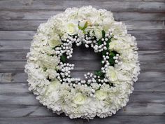 a wreath with white flowers and baby's breath