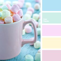 a cup filled with marshmallows sitting on top of a blue wooden table