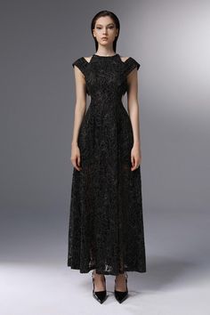 Crafted with intricate lace embroidery and a flattering A-line silhouette, this dress exudes elegance and luxury. The delicate cut-outs add a touch of sophistication, making it perfect for any special occasion. Elevate your style with this exclusive piece. Evening Lace Dress With A-line Silhouette, Evening A-line Dress With Lace Sleeves, Formal A-line Lace Maxi Dress, A-line Lace Dress For Evening, Maxi Length Evening Dress With Lace Trim For Gala, A-line Lace Dress For Gala, Fitted Evening Gown With Lace Patchwork, A-line Lace Evening Dress For Gala, Elegant Black A-line Gown