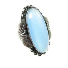 1960s MCM designer Carl Ove Frydensberg Denmark, sterling and cats-eye blue chalcedony ring. This singular Mid-Century Modern ring is done in a riff on Arts and Crafts design: a bezel-set oval cabochon of chalcedony is surrounded by a continuous chain, flanked by leaf and tendril motifs. The translucent stone is alive with sensuous movement; the workmanship is exquisite. A wildly collectible and rare artisan at his best! Stone, 25x10 mm. Signed "COF 925S". Size 6.75 Arts And Crafts Design, Blue Chalcedony Ring, Chalcedony Ring, Art And Craft Design, Sterling Necklaces, Cats Eye, Modern Ring, Blue Chalcedony, Vintage Costume Jewelry