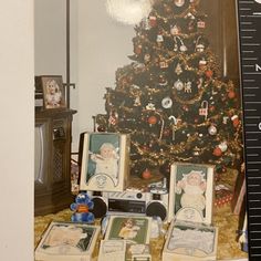 a christmas tree is decorated with pictures and other ornaments in front of a large ruler