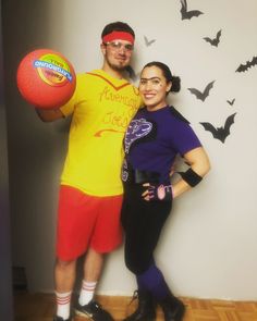 a man and woman in halloween costumes posing for a photo