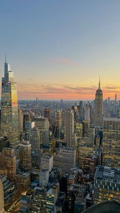 the city skyline is lit up at night, with skyscrapers in the foreground