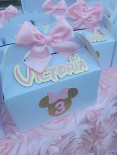 there are many boxes that have pink bows on them and the name victoria in gold