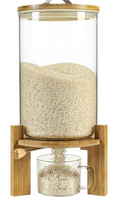 a grain dispenser with a wooden stand and glass container on the top