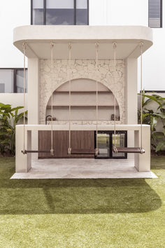 an outdoor kitchen with wooden cabinets and hanging bars