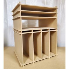 the shelf is made out of plywood and has six compartments for storing books or magazines