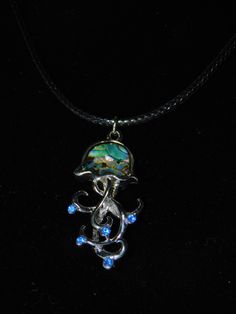 This Beautiful Jelly fish pendant is gorgeous for any occasion. Made with 18" rope with a lobster claw closure. Jellyfish spiritually symbolize acceptance and faith, surrendering to the waves without struggling or sinking in emotionally challenging times. Ocean-inspired Jewelry With Lobster Clasp And Round Pendant, Adjustable Ocean-inspired Round Pendant Jewelry, Unique Jewelry With Fish Hook For Gift, Fish Pendant Necklace, Fish Pendant, Lobster Claws, Jelly Fish, Challenging Times, Jellyfish