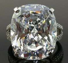 an oval cut diamond ring with diamonds around it