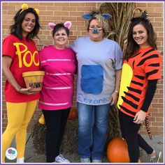 three women dressed up as winnie the pooh and eey - o's