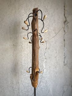 a wooden pole with lights attached to it in front of a wallpapered background