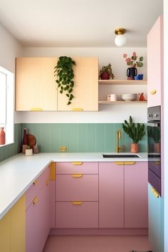 a kitchen with pink cabinets and green tiles on the backsplash is seen in this image