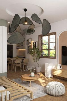 a living room filled with furniture and a flat screen tv mounted to the wall next to a window