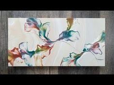 an abstract painting on wood with flowers painted on it