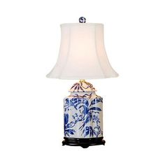 a blue and white lamp with a shade on it