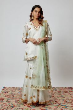 Ivory pure spun silk kurta with gota patti hand embroidery. Comes with sharara and a sea green organza dupatta. - Aza Fashions Bollywood Tissue Silk Palazzo Set For Wedding, Festive Off White Chanderi Palazzo Set, White Lehenga With Dabka Work For Wedding, Tissue Silk Palazzo Set For Wedding Eid, White Lehenga For Wedding With Dabka Work, Tissue Silk Palazzo Set For Wedding And Eid, Off White Designer Wear Sets For Transitional Season, Wedding Palazzo Set In Tissue Silk For Eid, Festive Off-white Gota Work Sets