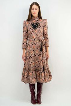 - the paisley print is back in stock  - vintage britain 70’ glam rock silhouette with victorian styling  - heart embroidery with sweeping ruffled hem and tassel detail self-belt  - heirloom quality construction    style it    - for any occasion you want to impress  - luxurious velvet evokes a vintage feel    pre-order for 10/10 delivery Heart Embroidery, Glam Rock, Mid Dresses, Back In Stock, Gift Store, Corporate Gifts, Paisley Print, Pre Order, Paisley