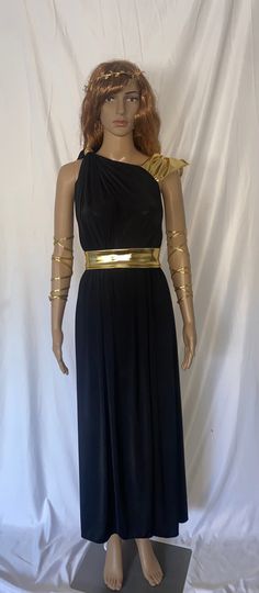 a mannequin wearing a black dress with gold trims on it's arms