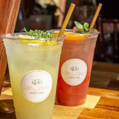 two drinks sitting next to each other on a table