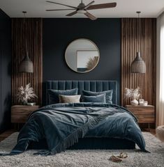 a bedroom with dark blue walls and a large bed in front of a round mirror