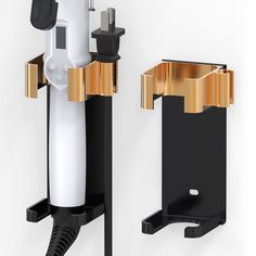 two black and gold wall mounted hair dryers next to each other on a white background