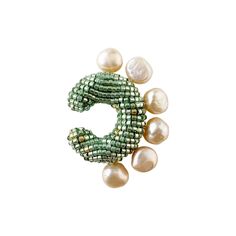 This Earcuff is sold as a single unit piece for use on one ear. Non-adjustable design COLOR: MINT GREEN PEARLSHEIGHT: 4 cm / 1.5 in WIDHT: 3.1 cm / 1.2 in WEIGHT: 9 gr / 0.4 oz UNITMATERIALS: Glass Beads, natural pearls, resin. Our jewelry is hand-creafted with the utmost care and a slight variation may exist between pieces. Our metallic parts are composed of 24kt gold plated bronze or Rhodium plated silver 925. Green Handmade Ear Cuff For Gift, Pink Olive, Green Pearls, 24kt Gold, Ring Collections, Silver Pearls, Natural Pearls, Design Color, Purple Gold