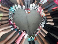 a group of children's shoes arranged in the shape of a heart