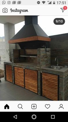 an outdoor kitchen made out of wood and stone