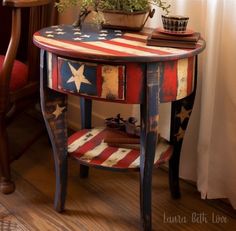 an american flag painted side table with potted plants on top and two chairs in the background