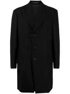 black wool peak lapels front button fastening shoulder pads long sleeves buttoned cuffs chest welt pocket two front flap pockets English rear vents full lining Black Wool Long Coat With Concealed Front, Black Long Wool Coat With Concealed Fastening, Modern Black Wool Coat With Concealed Placket, Designer Wool Coat With Concealed Placket And Lapel Collar, Designer Wool Coat With Lapel Collar And Concealed Placket, Modern Black Wool Coat With Button Closure, Black Wool Blazer With Concealed Fastening, Classic Wool Coat With Concealed Front Fastening For Business, Black Designer Wool Coat With Button Closure