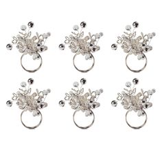 four silver rings with pearls and beads on each one side, in the shape of flowers