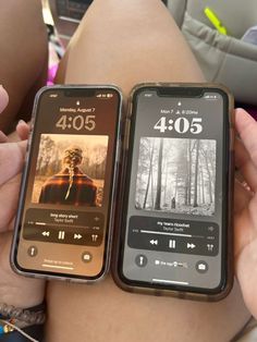 two cell phones sitting next to each other on a person's lap in the back seat