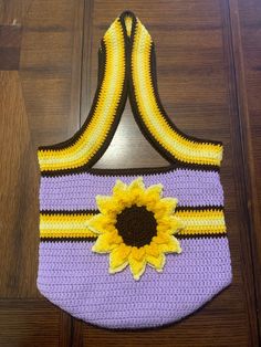 Large Crocheted Lavender Sunflower Tote Bag Add a unique touch to your wardrobe with this lavender crocheted tote bag with sunflower accent.   Buy it for yourself or as a gift. Dimensions of bag not including handles: 14 inches wide 11.5 inches tall Sunflower Crochet Bags, Yellow Bohemian Crochet Tote Bag, Crocheted Lavender, Sunflower Purse Crochet, Lavender Sunflower, Sunflower Crochet Bag Purple, Crocheted Sunflower, Sunflower Tote Bag, Crochet Sunflower