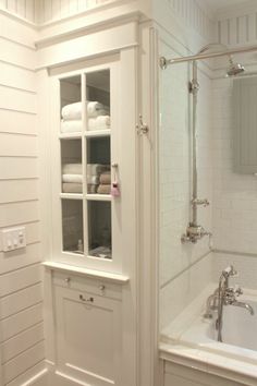 a bathroom with white walls and flooring next to a bathtub