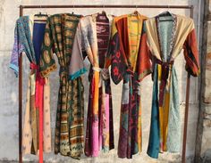 Silk kimono Robes are perfect for lounging around the home or spa. Use our Recycle Saree Silk robe as a cover up on the beach or after a dip in the pool. Add a luxe, boho feel to your bridal shower. Versatile, soft and luxurious, our 100% Silk kimono robes are printed with azo-free dyes. The Recycle Saree Silk robe features 3/4th sleeves, a waist tie and two front pocket. Size - One size will fit sizes S to XXL Length - 50 inches (125 Centimeter), mid calf Note: Girl wear the kimono has height 5.3' feet Measurements Approx : *Bust Around Size: 48" Inches *Sleeve Length: 14" Inches *Sleeve hole: 12" Inches *2 Side Pockets One size - loose and comfy to fit any size Length-50 INCHES APPROX "[130cm ] The drawstring at waistline can be tightened as much as required or left relaxed. FREE SIZE Fa Vintage Multicolor Silk Kimono, Festive Multicolor Silk Kimono, Traditional Multicolor Silk Kimono, Kimono Belt, Belt Blouse, Dress Kimono, Silk Kimono Robe, Silk Robe, Womens Robes